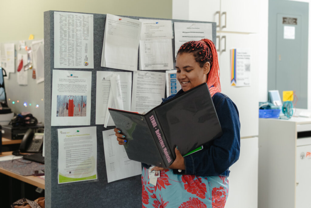A person looks at a binder.