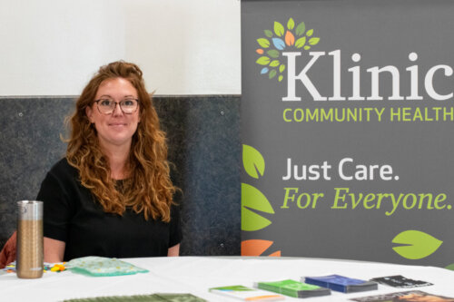 Erin sits at a table with resources.